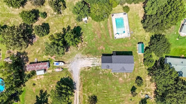 a front view of a house with garden patio and swimming pool
