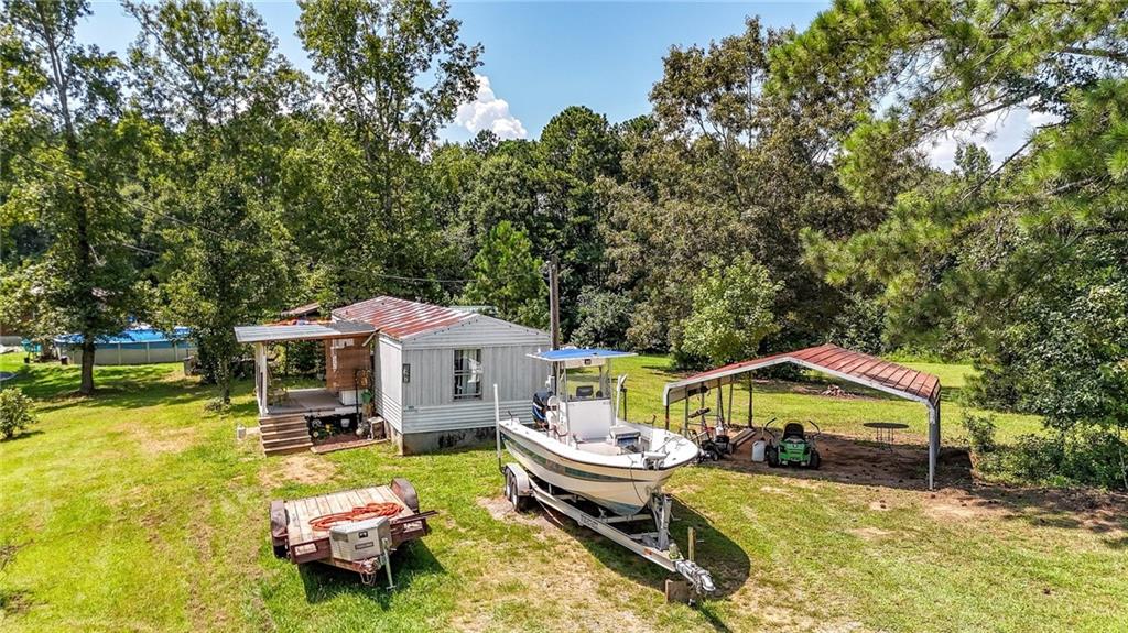 923 County Line Road Resaca, GA 30735 - Photo 41 of 49 a front view of a house with garden patio and swimming pool