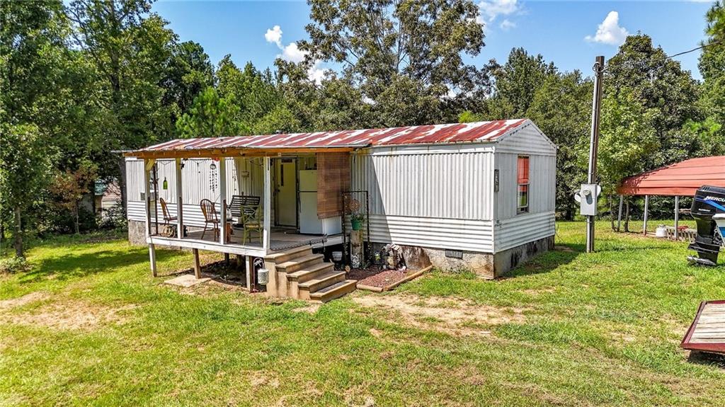 923 County Line Road Resaca, GA 30735 - Photo 42 of 49 a view of a backyard with a sitting area