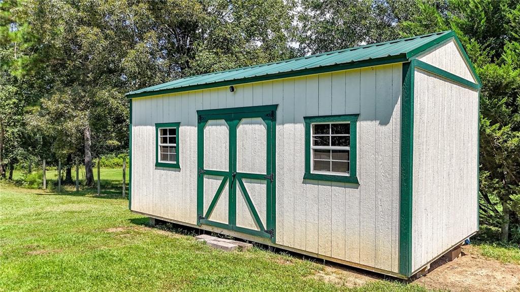 923 County Line Road Resaca, GA 30735 - Photo 44 of 49 a view of backyard with a barn and a cactus plant
