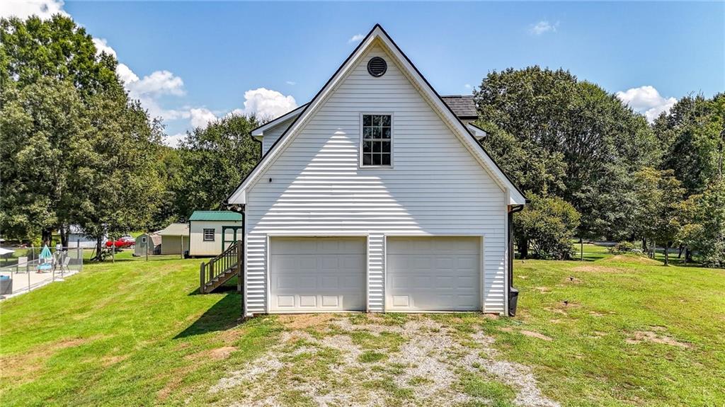 923 County Line Road Resaca, GA 30735 - Photo 6 of 49 a view of a house with yard and trees in the background