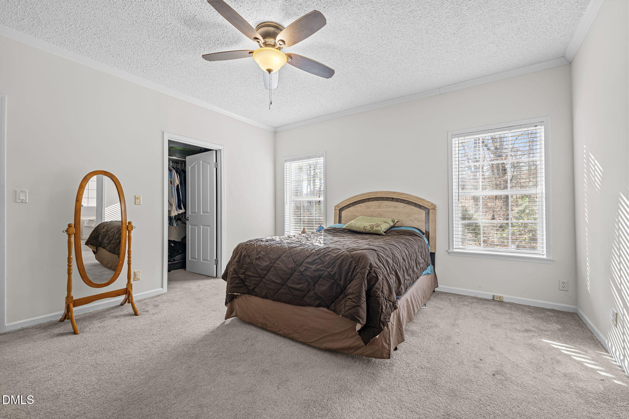 4501 Foreys Court Graham, NC 27253 - Photo 16 of 47 a spacious bedroom with a bed and a chandelier