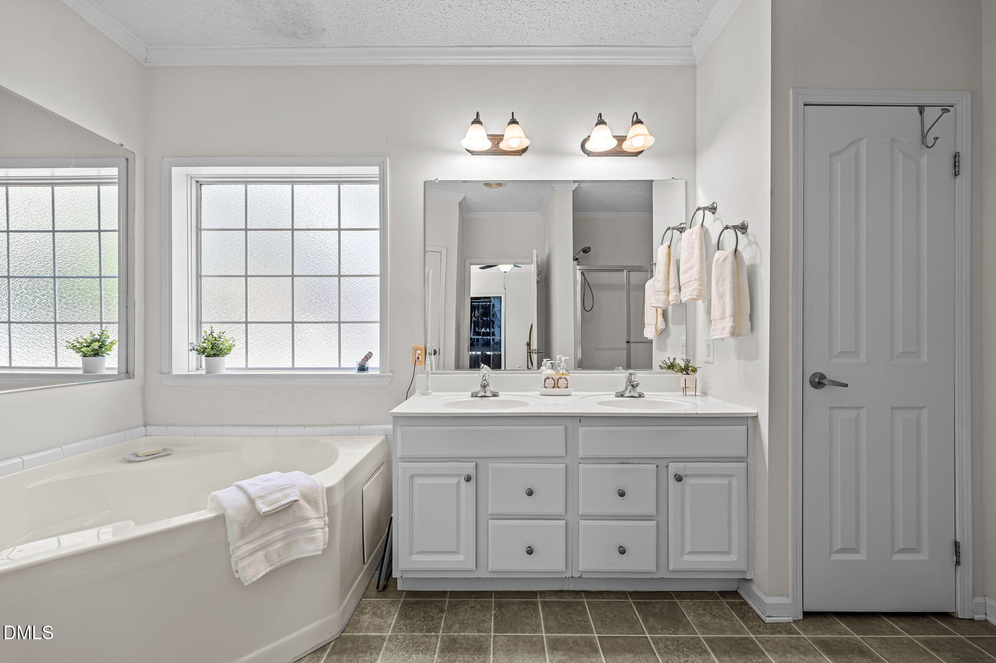 4501 Foreys Court Graham, NC 27253 - Photo 20 of 47 a spacious bathroom with a double vanity sink a large mirror a bathtub and window
