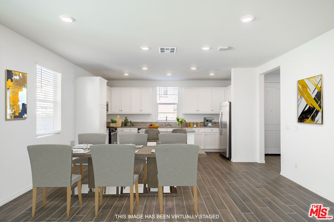 7935 Cold Creek Street Riverside, CA 92507 - Photo 11 of 45 a view of a dining room with furniture and wooden floor