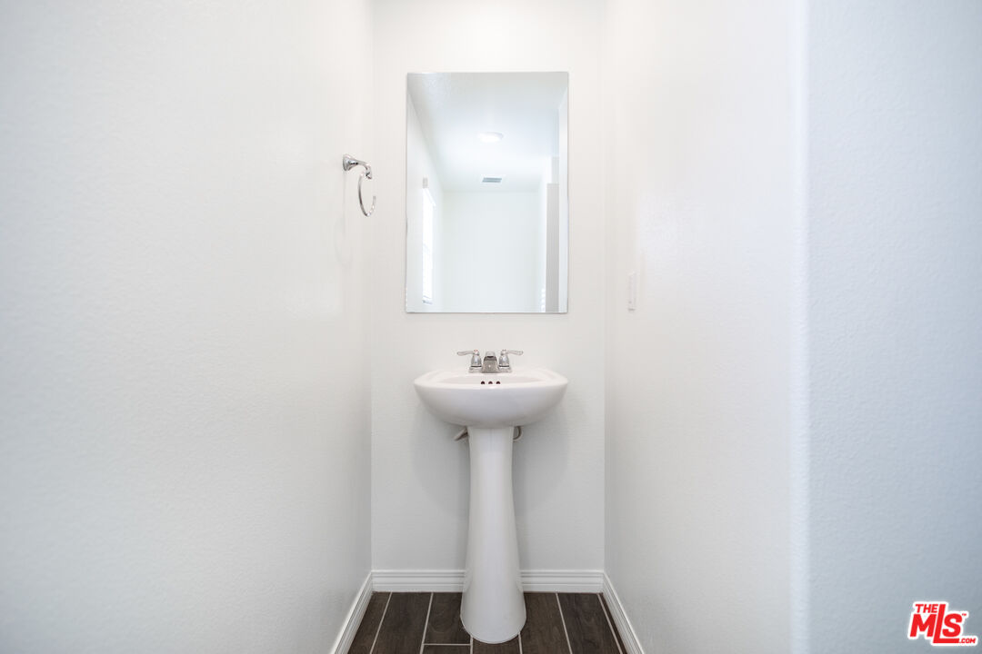 7935 Cold Creek Street Riverside, CA 92507 - Photo 16 of 45 a bathroom with a sink a toilet and mirror