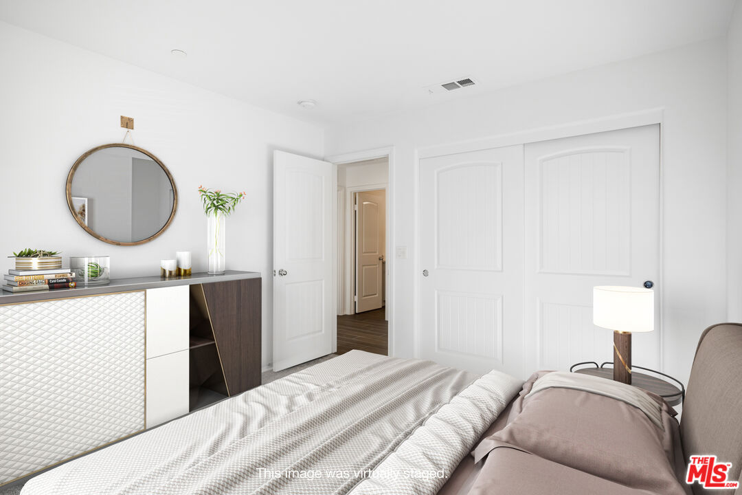 7935 Cold Creek Street Riverside, CA 92507 - Photo 22 of 45 a bedroom with a bed and a chandelier