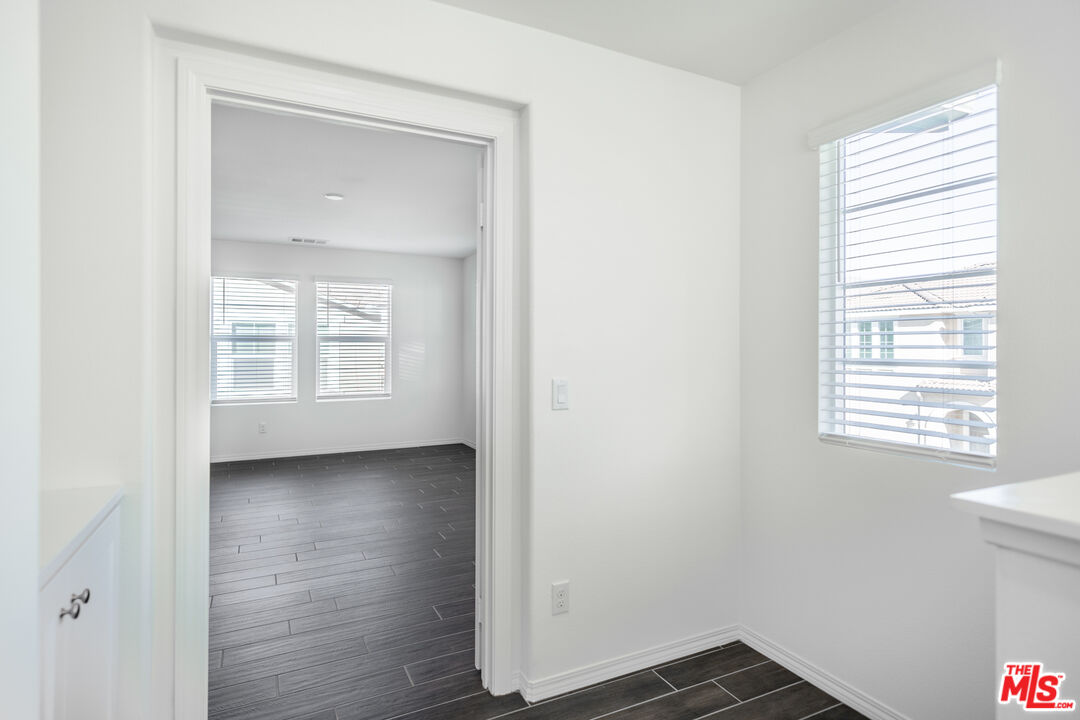 7935 Cold Creek Street Riverside, CA 92507 - Photo 29 of 45 a view of an empty room with wooden floor and a window