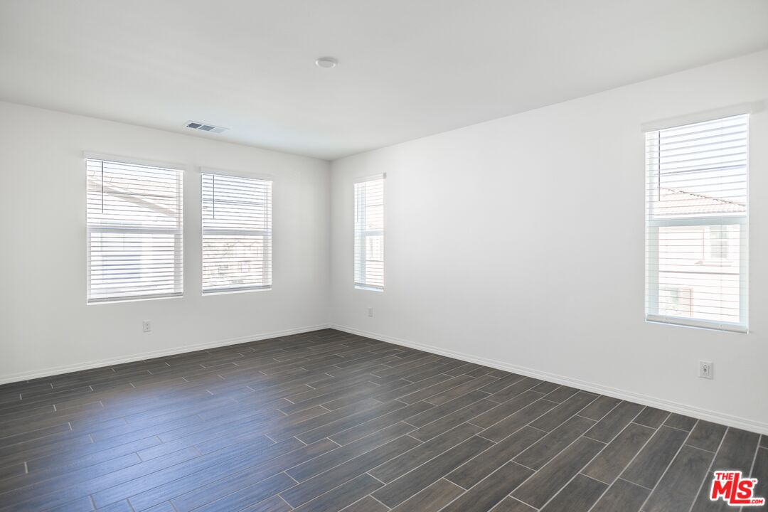 7935 Cold Creek Street Riverside, CA 92507 - Photo 30 of 45 an empty room with wooden floor and windows