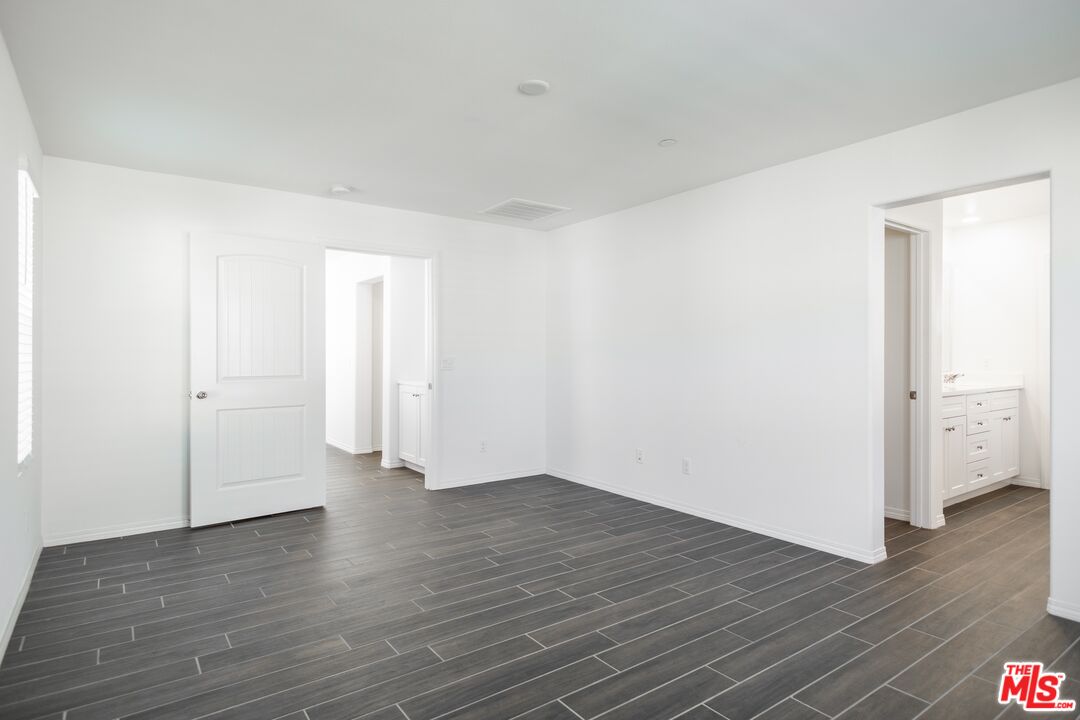 7935 Cold Creek Street Riverside, CA 92507 - Photo 32 of 45 a view of an empty room with wooden floor