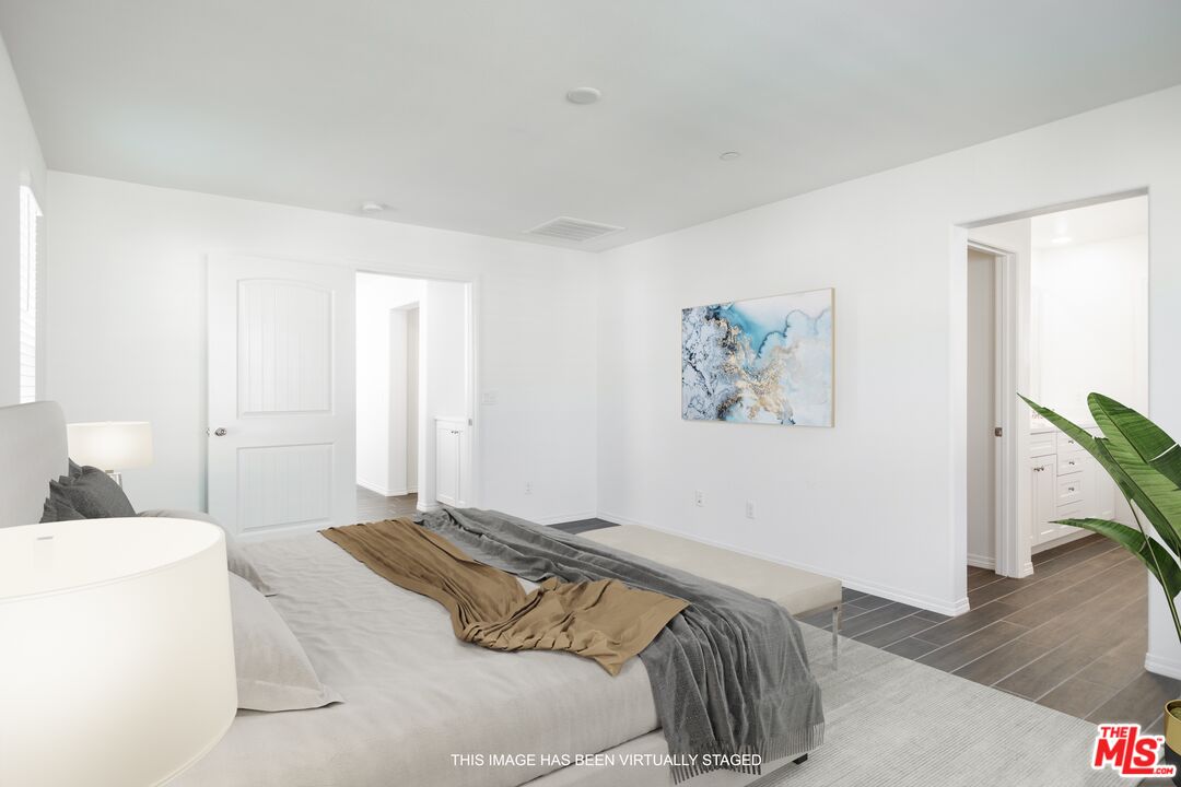7935 Cold Creek Street Riverside, CA 92507 - Photo 33 of 45 a bedroom with a bed and a wooden floor