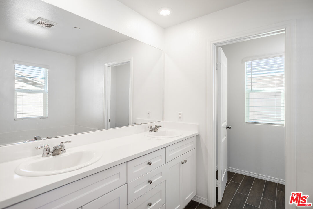 7935 Cold Creek Street Riverside, CA 92507 - Photo 34 of 45 a bathroom with a sink and a mirror
