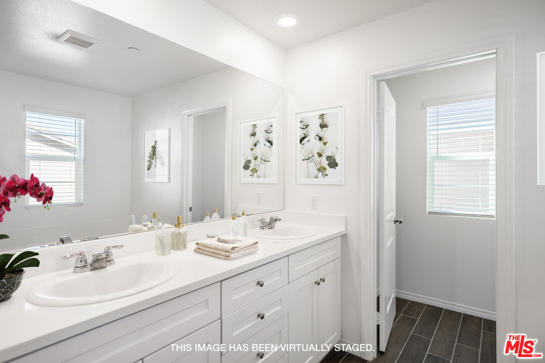 7935 Cold Creek Street Riverside, CA 92507 - Photo 35 of 45 a bathroom with a double vanity sink and a mirror