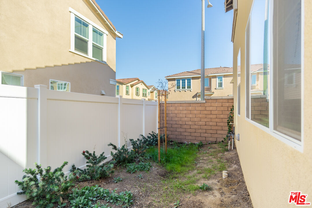 7935 Cold Creek Street Riverside, CA 92507 - Photo 44 of 45 a view of a brick building next to a yard