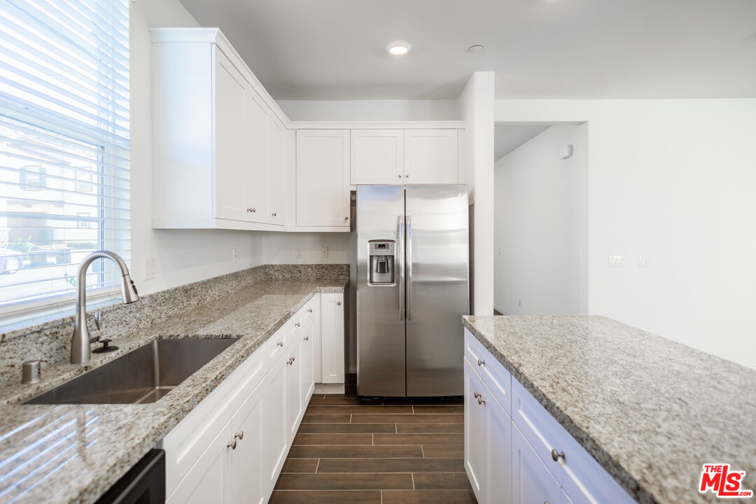 7935 Cold Creek Street Riverside, CA 92507 - Photo 6 of 45 a kitchen with stainless steel appliances granite countertop a sink stove and refrigerator