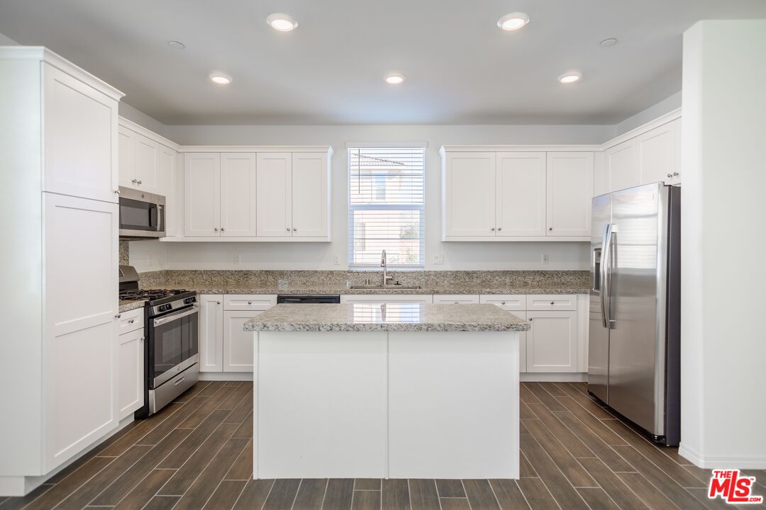 7935 Cold Creek Street Riverside, CA 92507 - Photo 7 of 45 a kitchen with a sink stove and refrigerator