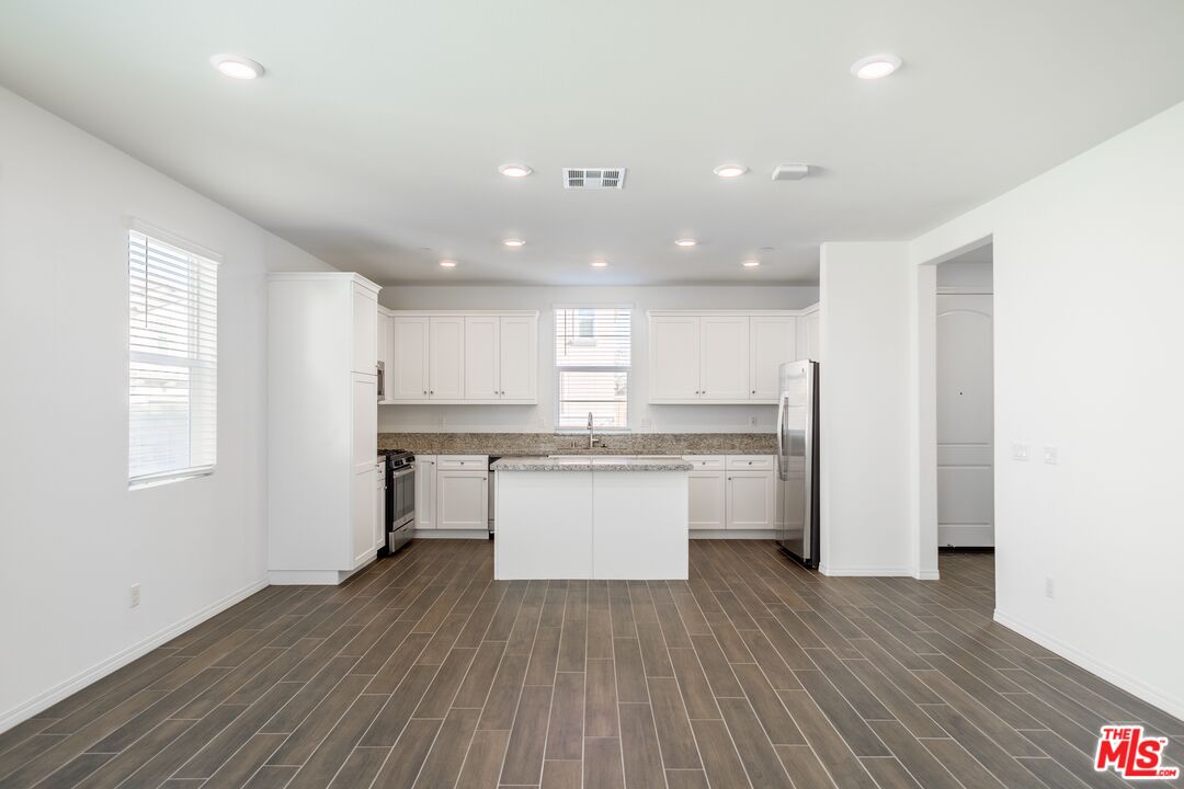 7935 Cold Creek Street Riverside, CA 92507 - Photo 10 of 45 a kitchen with a white wooden cabinets and window