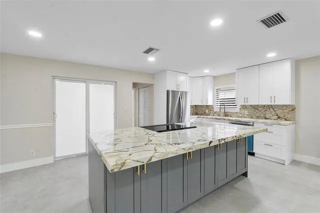 a kitchen with granite countertop cabinets and refrigerator