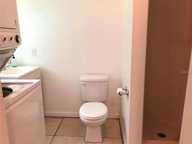 a white toilet sitting next to a white sink