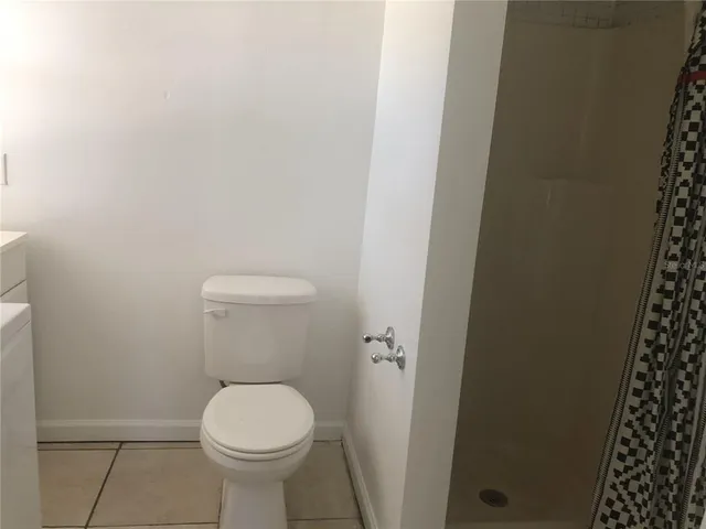 a white toilet sitting next to a small bathroom