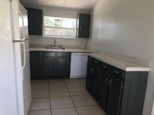 a kitchen with a sink stove and refrigerator