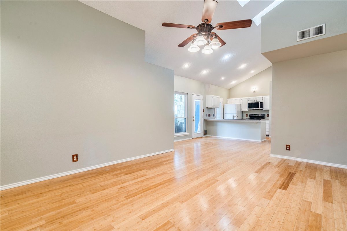 3809 Spicewood Springs Road, Unit 127 Austin, TX 78759 - Photo 3 of 29 Luminous hard-surface flooring flows through this open concept living area into the functional kitchen.