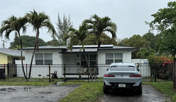 a view of a house with backyard porch and sitting area