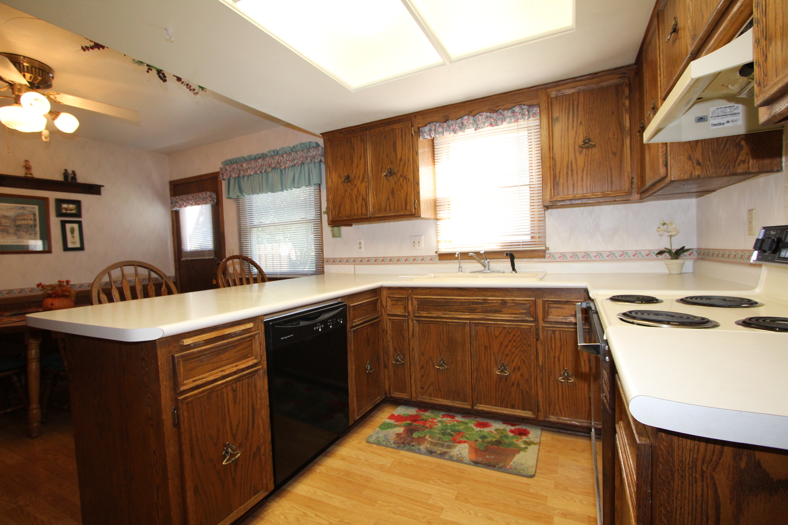 603 Old Orchard Road Harvard, IL 60033 - Photo 3 of 46 a kitchen with a sink stove and cabinets