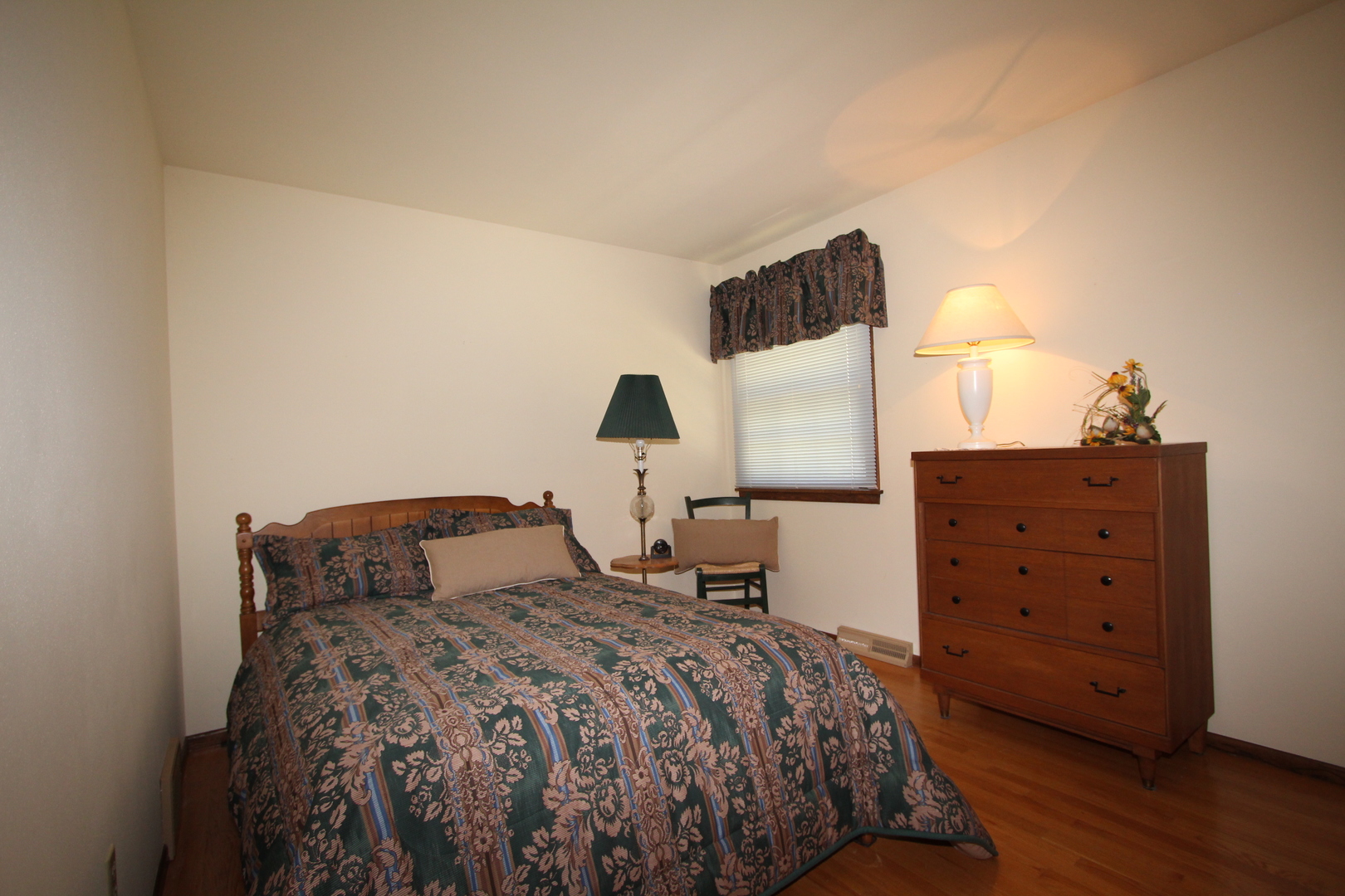603 Old Orchard Road Harvard, IL 60033 - Photo 23 of 46 a bedroom with a bed and wooden floor