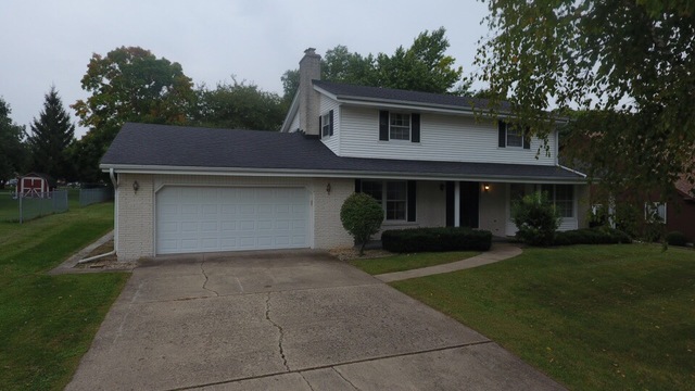 603 Old Orchard Road Harvard, IL 60033 - Photo 33 of 46 a front view of a house with a yard and garage