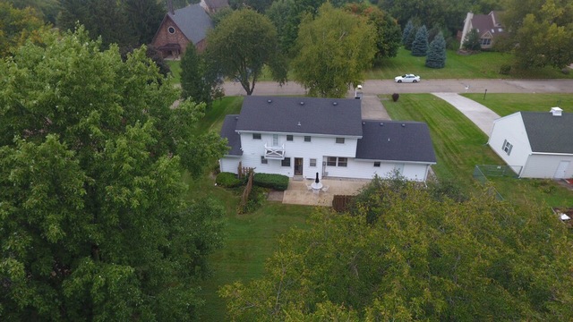 603 Old Orchard Road Harvard, IL 60033 - Photo 45 of 46 an aerial view of a house with outdoor space and trees all around