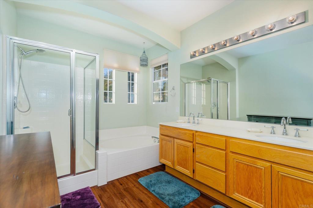 16350 Open View Road Ramona, CA 92065 - Photo 16 of 45 a bathroom with a tub a sink and mirrors