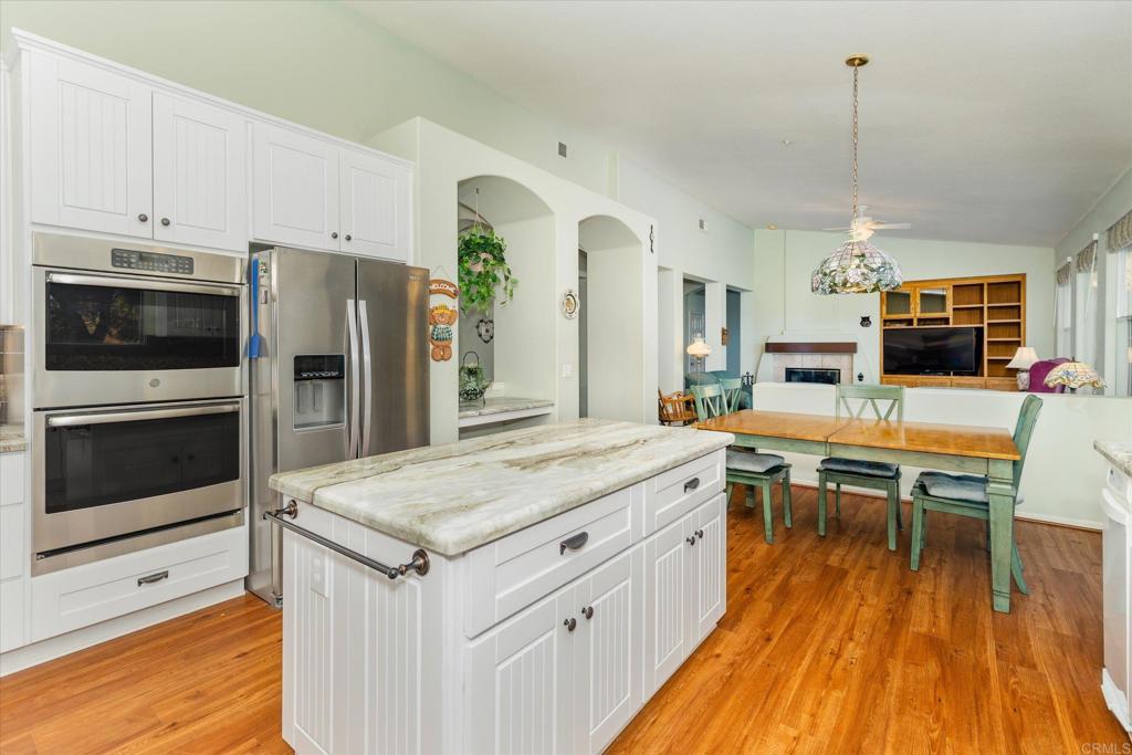 16350 Open View Road Ramona, CA 92065 - Photo 2 of 45 a kitchen with kitchen island a counter top space a sink stainless steel appliances and cabinets
