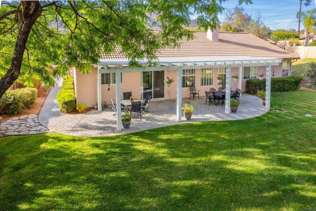 16350 Open View Road Ramona, CA 92065 - Photo 21 of 45 a view of a patio with table and chairs under an umbrella