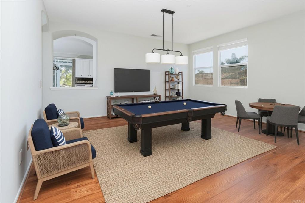 16350 Open View Road Ramona, CA 92065 - Photo 8 of 45 a living room with furniture a chandelier and a flat screen tv
