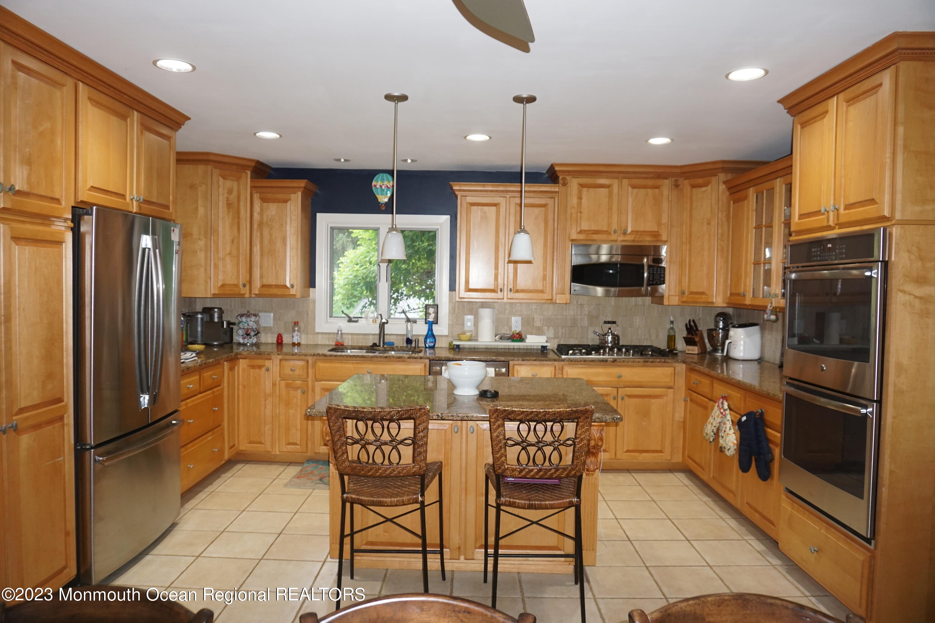 114 Bruce Road Red Bank, NJ 07701 - Photo 7 of 14 a kitchen with stainless steel appliances granite countertop a refrigerator and a stove top oven