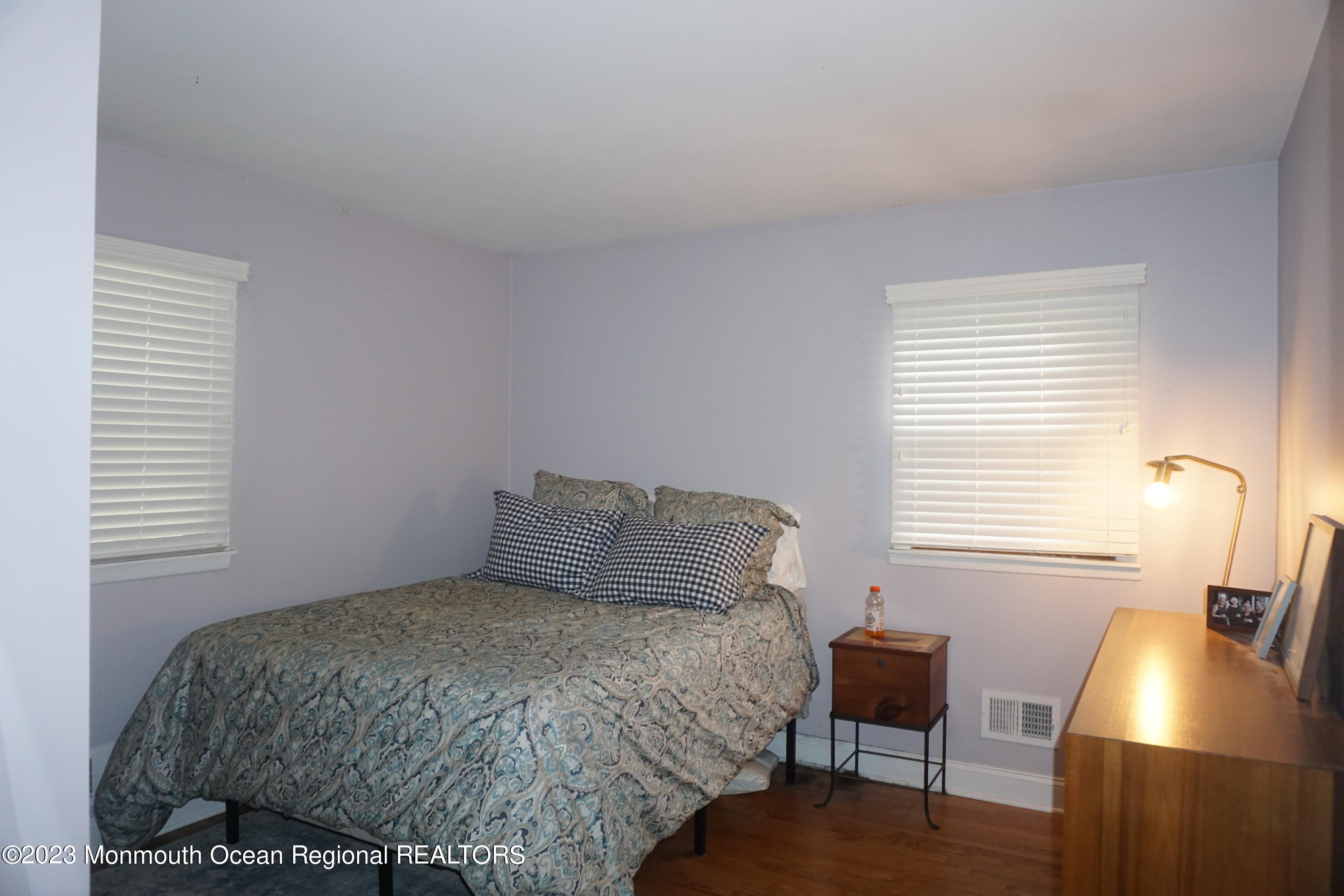 114 Bruce Road Red Bank, NJ 07701 - Photo 8 of 14 a bedroom with a bed and a chair