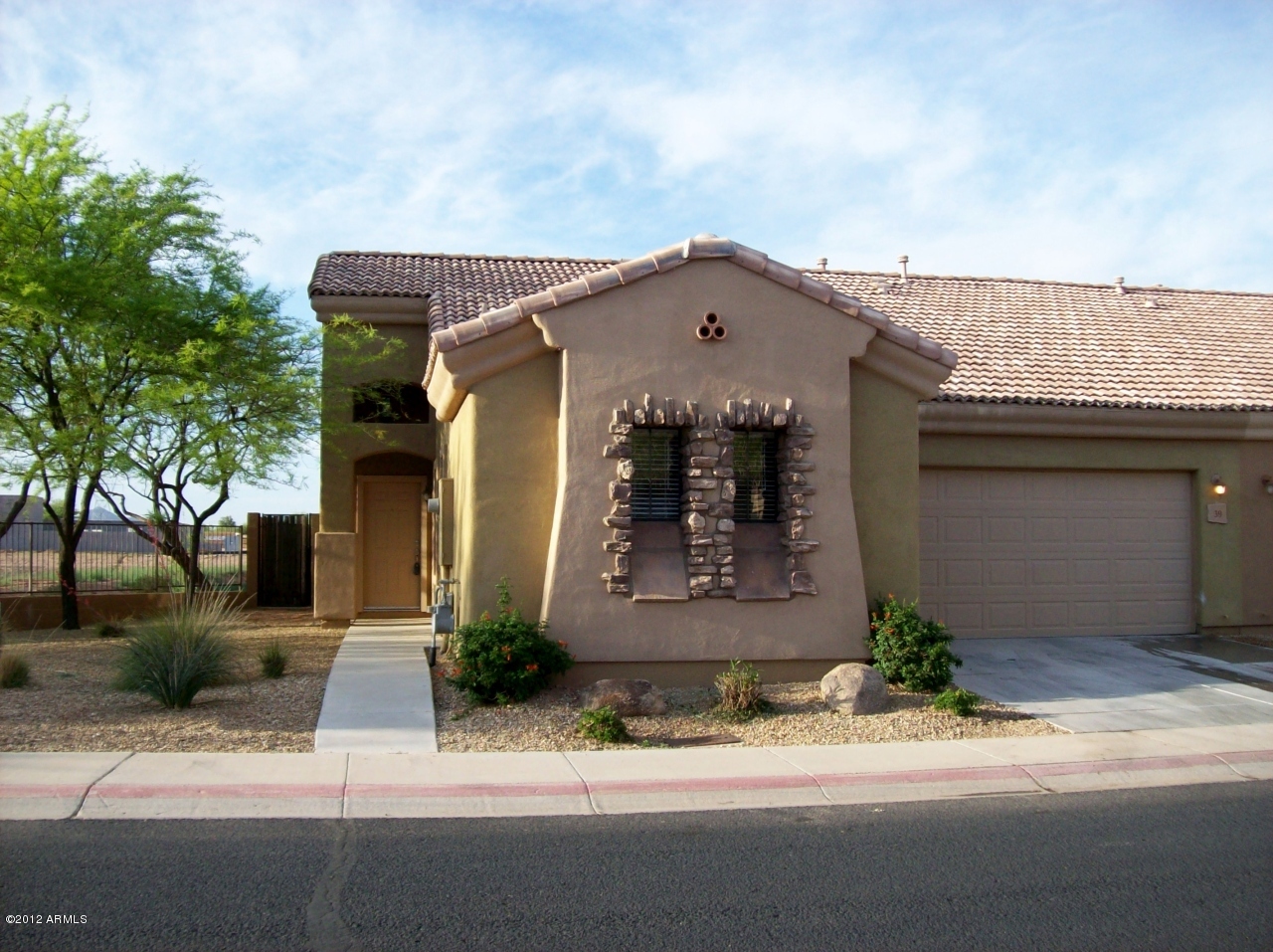2565 South Signal Butte Road, Unit 39 Mesa, AZ 85209 - Photo 1 of 28 a front view of a house with a yard and garage