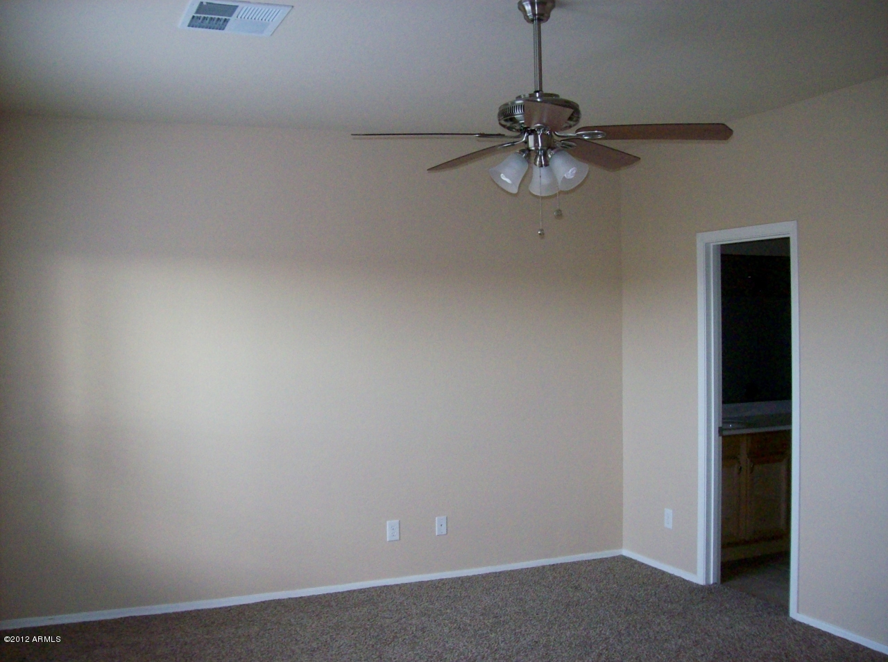2565 South Signal Butte Road, Unit 39 Mesa, AZ 85209 - Photo 11 of 28 a room with a chandelier fan and a window