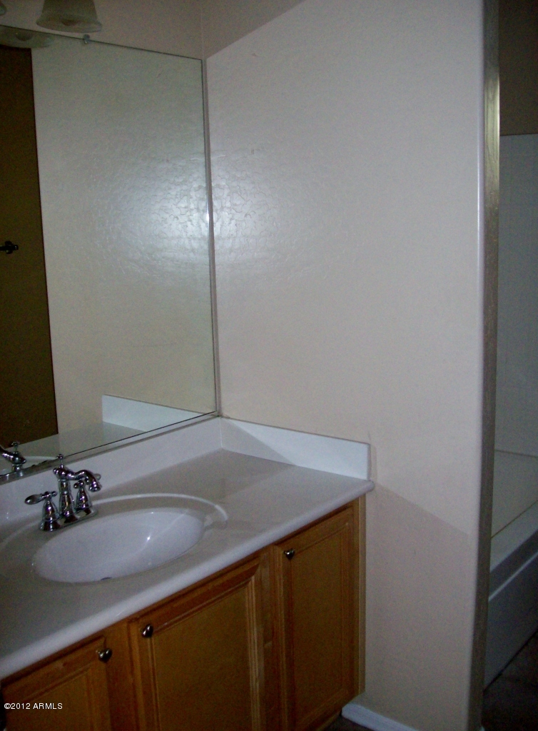 2565 South Signal Butte Road, Unit 39 Mesa, AZ 85209 - Photo 16 of 28 a bathroom with a sink and a mirror