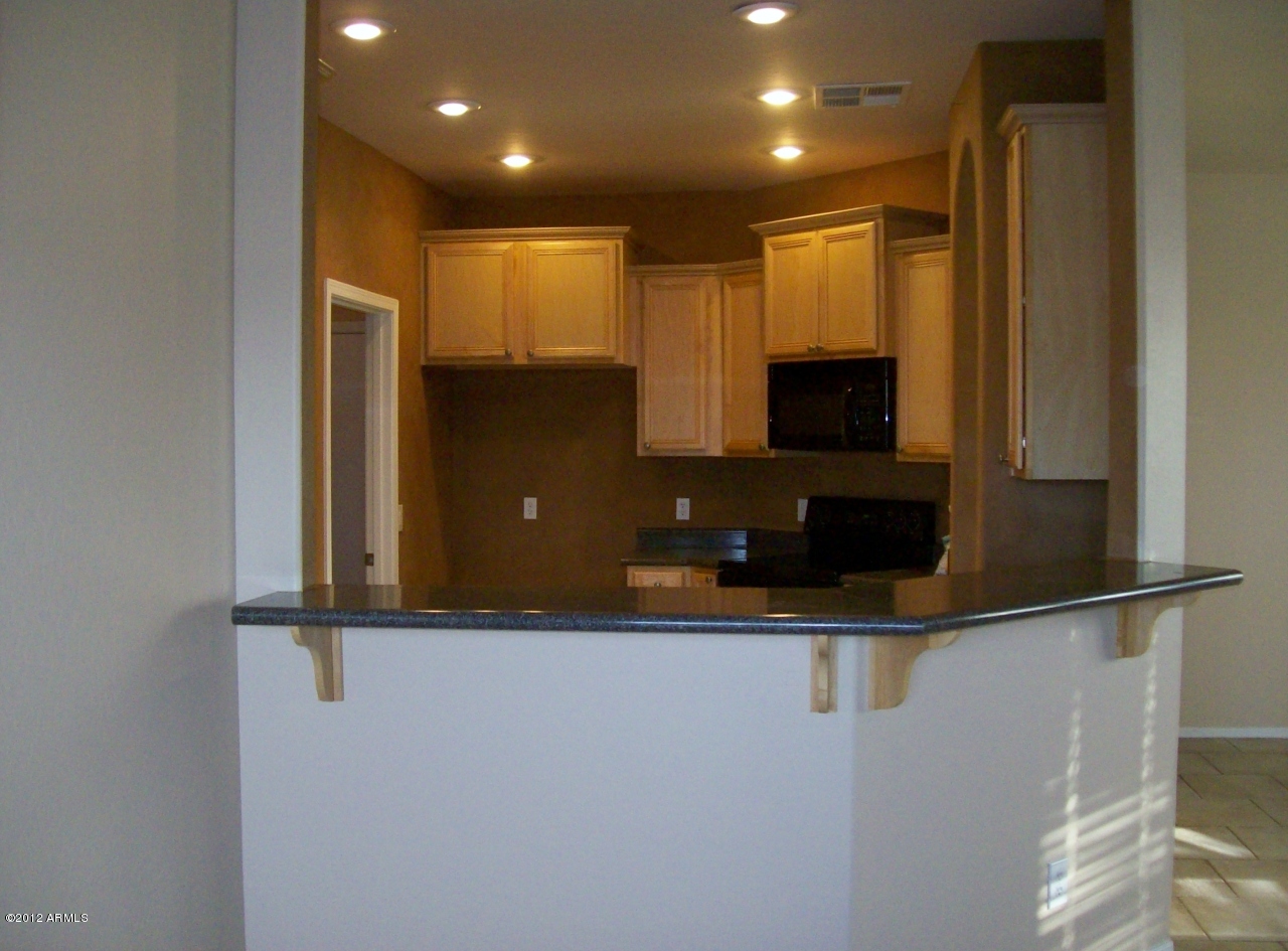 2565 South Signal Butte Road, Unit 39 Mesa, AZ 85209 - Photo 4 of 28 a view of a refrigerator and a microwave