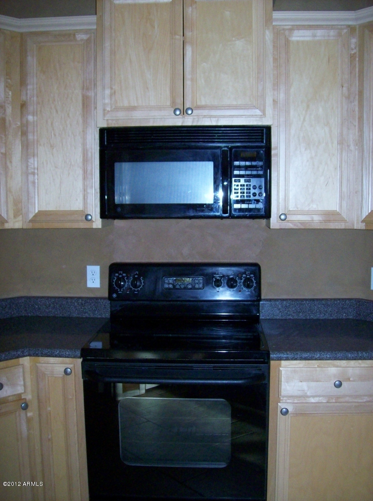 2565 South Signal Butte Road, Unit 39 Mesa, AZ 85209 - Photo 6 of 28 a stove top oven sitting inside of a kitchen