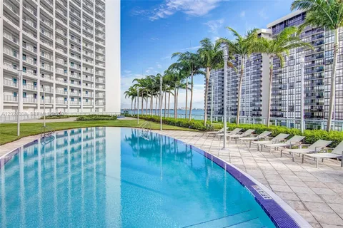 a view of swimming pool with chairs