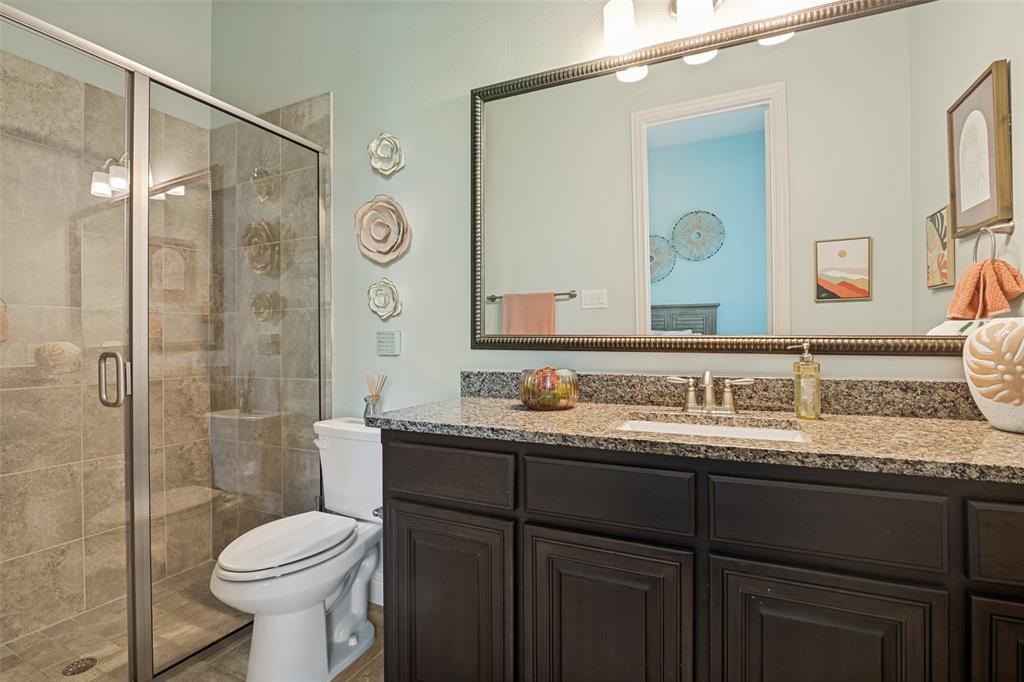 388 Bethany Road Sunnyvale, TX 75182 - Photo 21 of 40 Full bathroom featuring a walk-in shower with tile surround, glass enclosure, and integrated bench