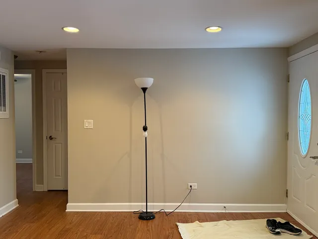 a view of a room with wooden floor