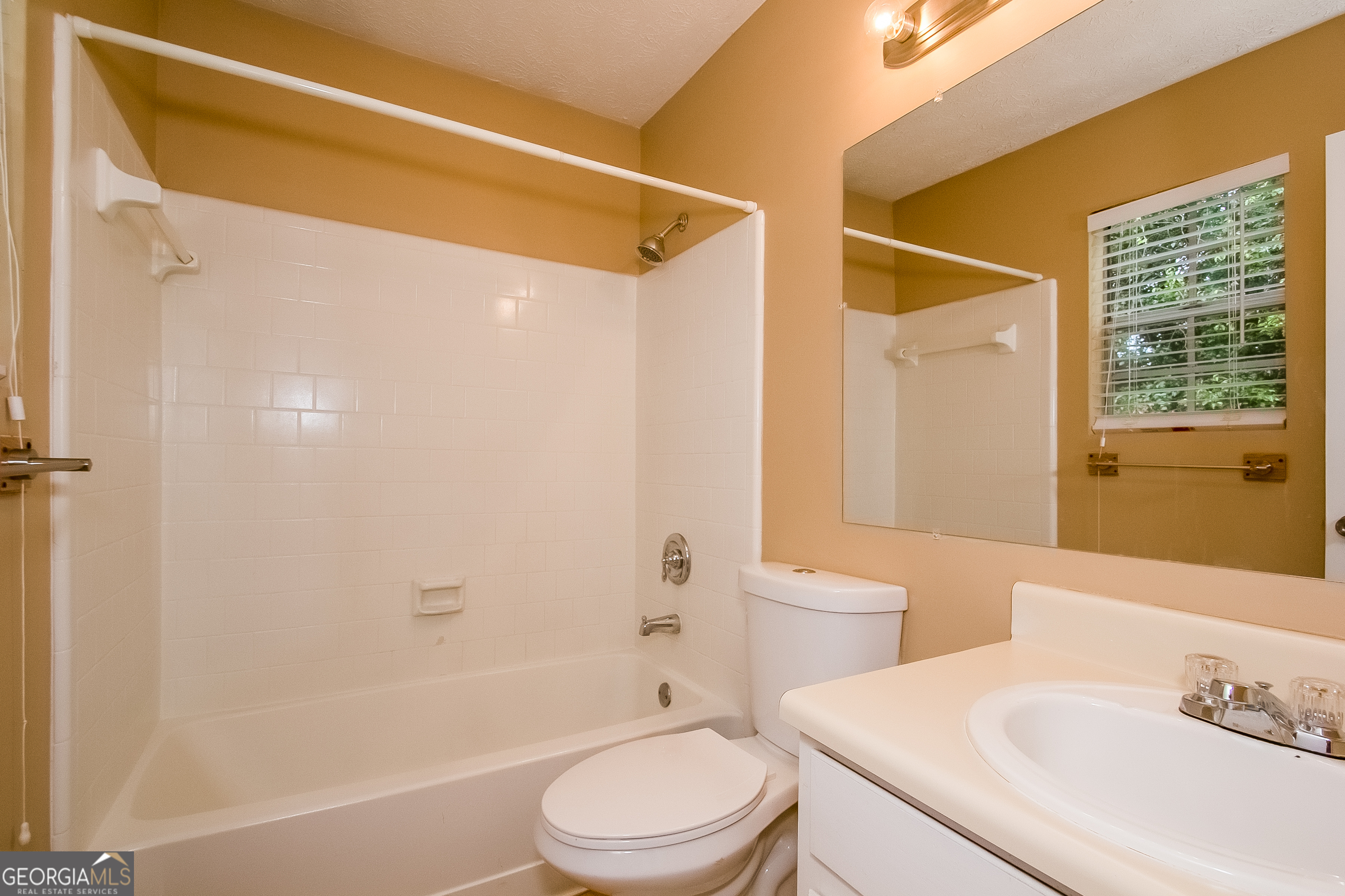 6350 Laurel Post Drive Lithonia, GA 30058 - Photo 13 of 15 a bathroom with a sink a toilet and shower