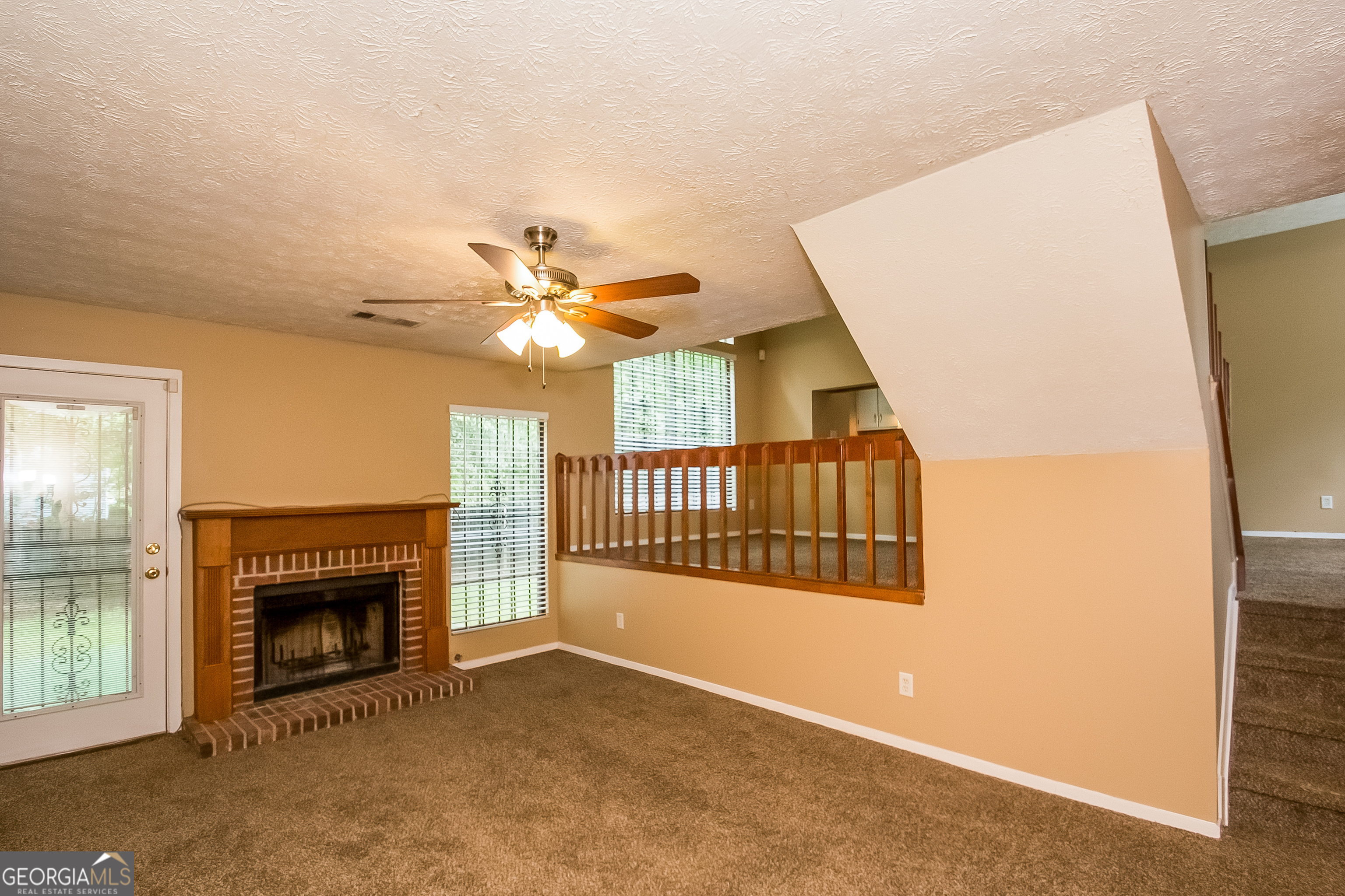 6350 Laurel Post Drive Lithonia, GA 30058 - Photo 8 of 15 a view of an empty room with a fireplace and a window
