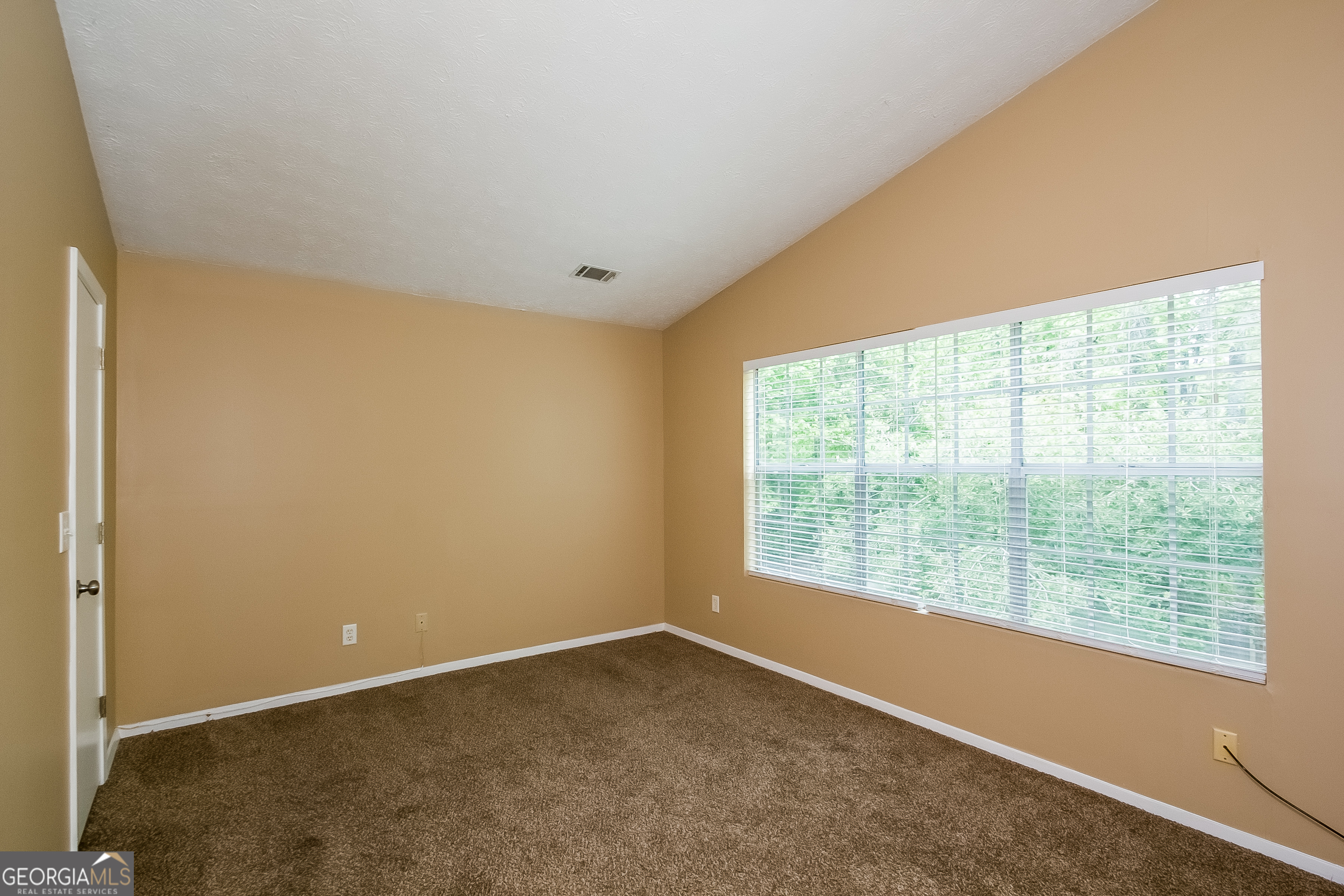 6350 Laurel Post Drive Lithonia, GA 30058 - Photo 10 of 15 a view of an empty room with a window
