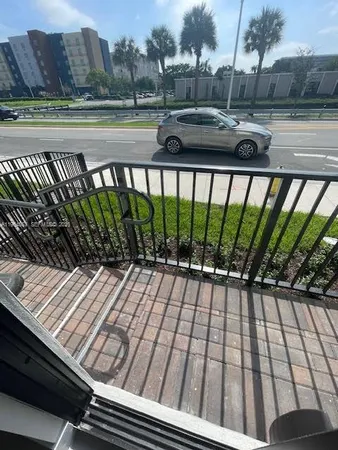 a view of a balcony with wooden floor and outdoor space