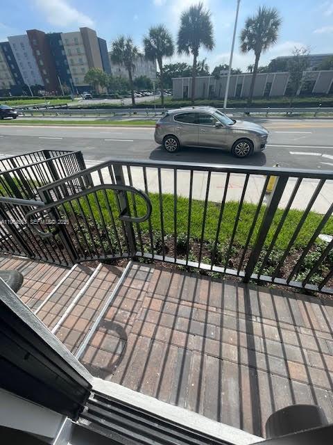 8167 Northwest 41st Street, Unit E111 Doral, FL 33166 - Photo 2 of 14 a view of a balcony with wooden floor and outdoor space
