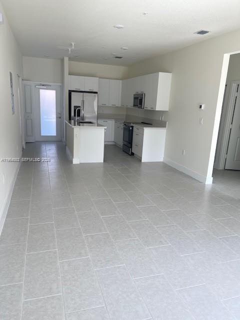 8167 Northwest 41st Street, Unit E111 Doral, FL 33166 - Photo 4 of 14 a view of a kitchen with furniture and an empty room